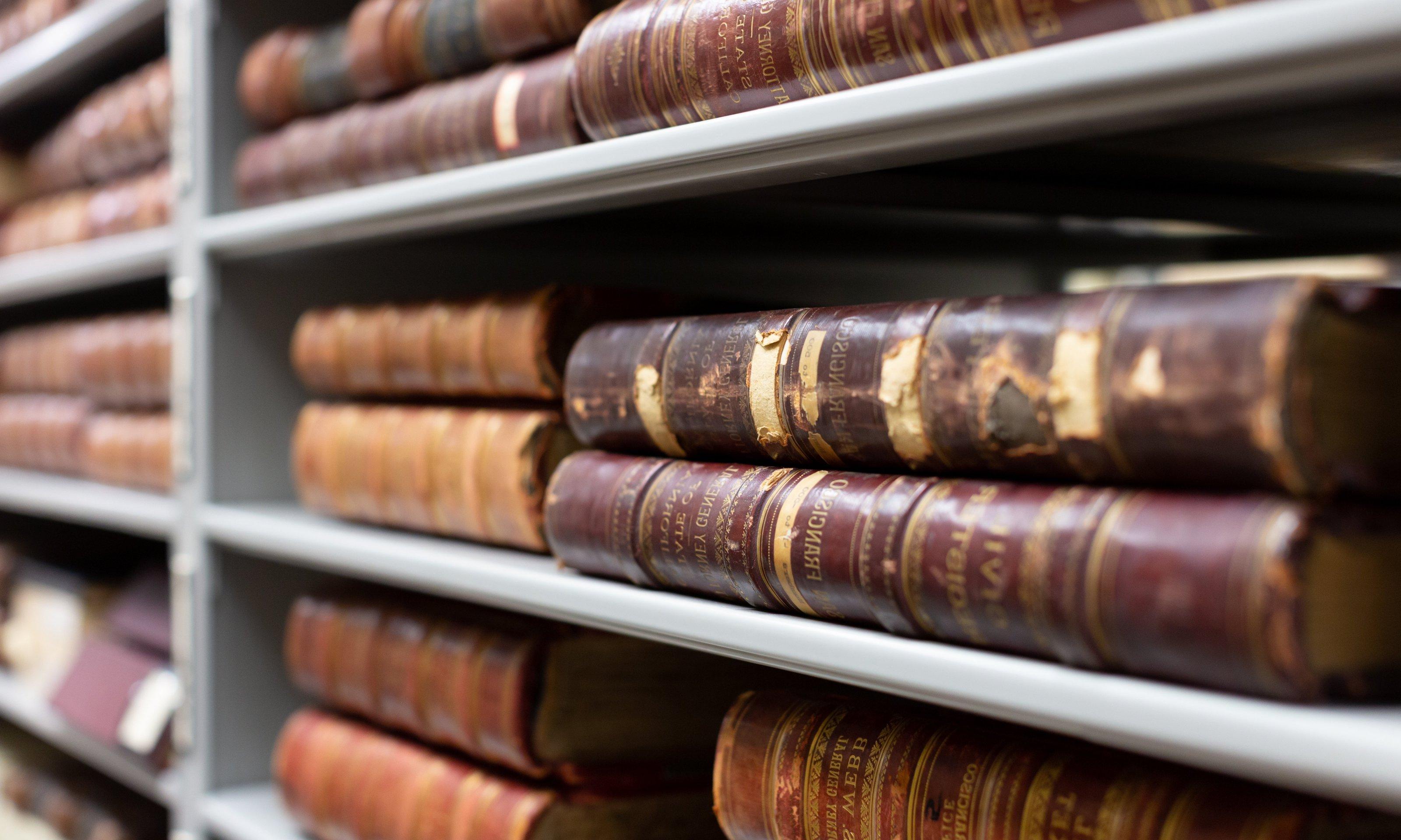 Stacks of old books on shelf