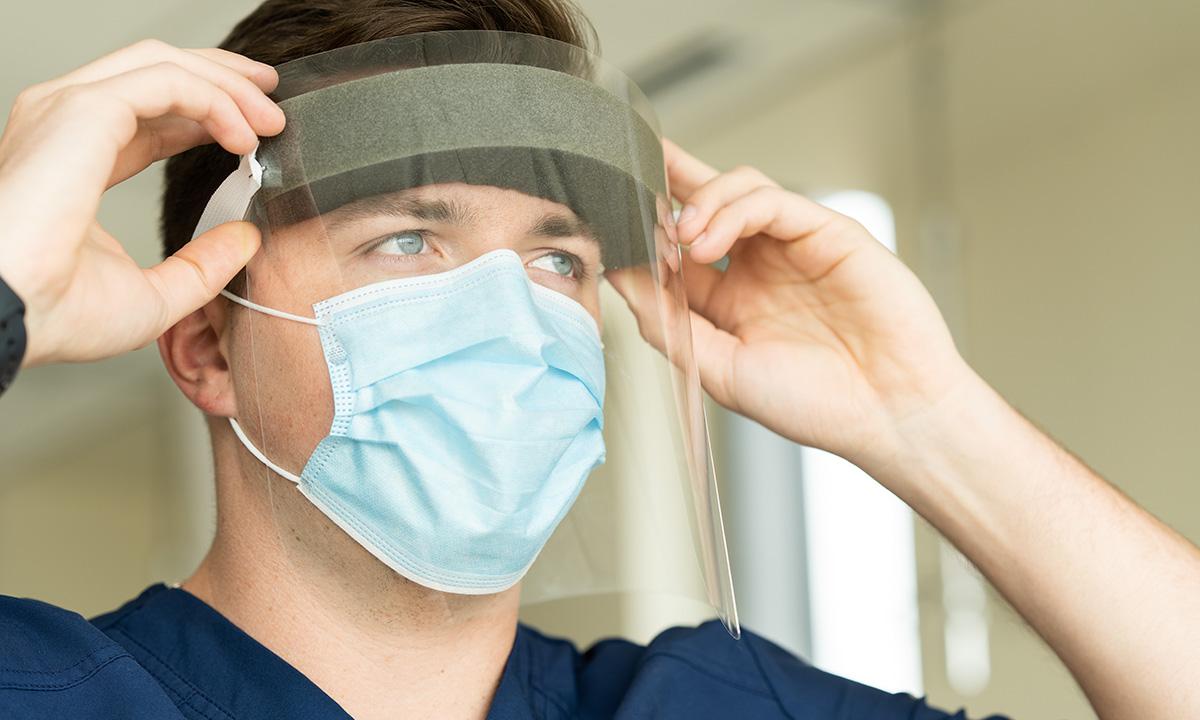 Man putting on personal protective gear