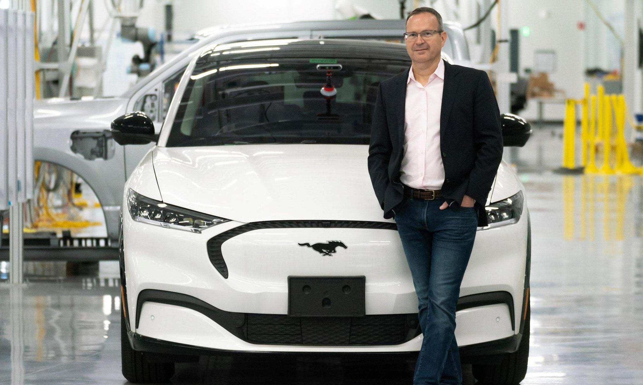 A man standing in front of a car