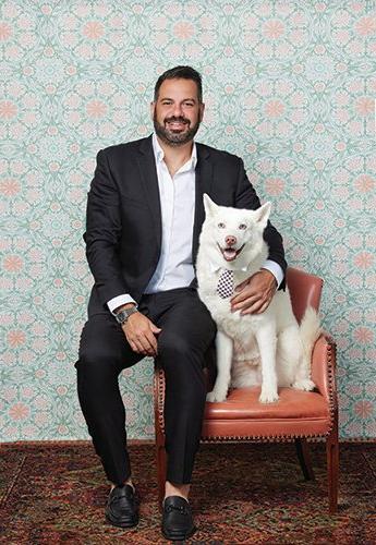 A man with his dog posing for a photo