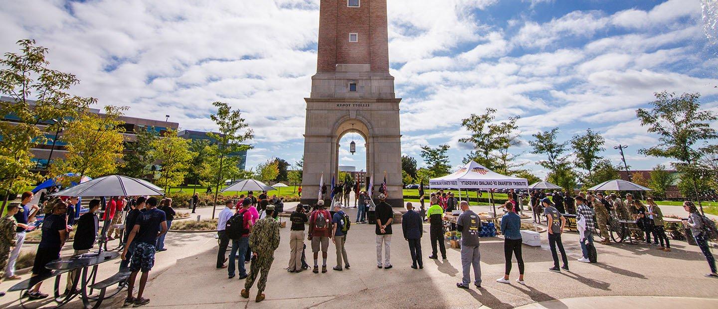 group of people standing in front of a clock tower